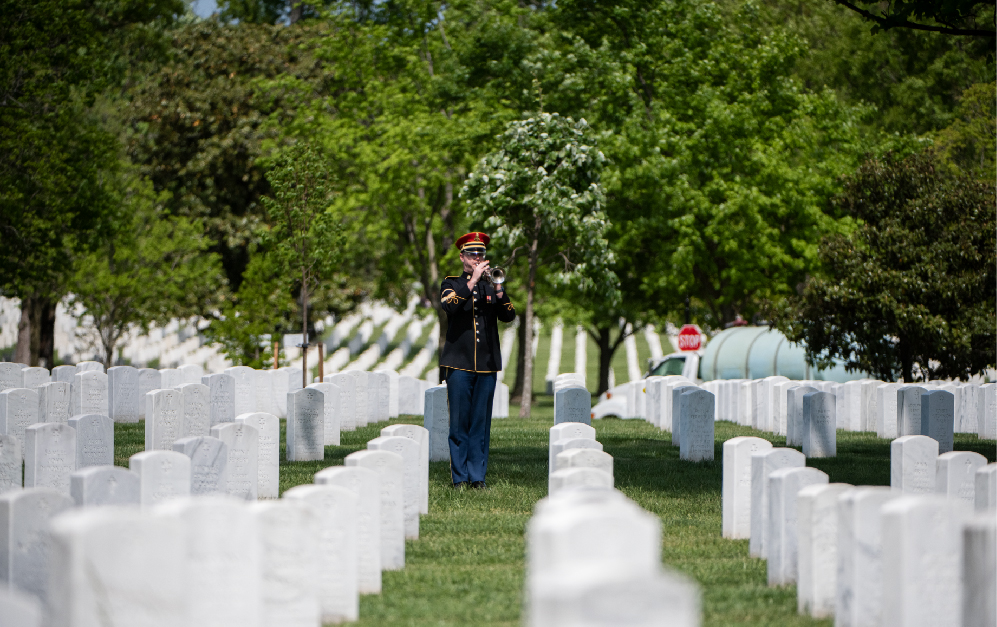 Honor Guard in military cemetery playing trumpet