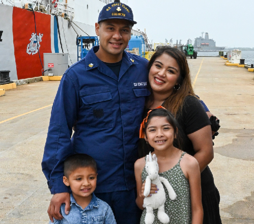 Coast Guard sailor with wife and 2 kids at port